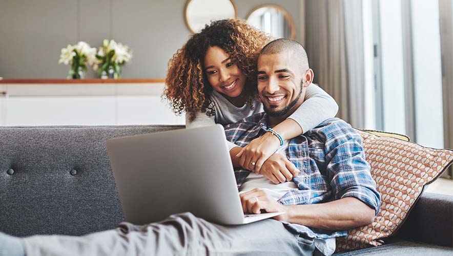 2 people looking at a laptop computer